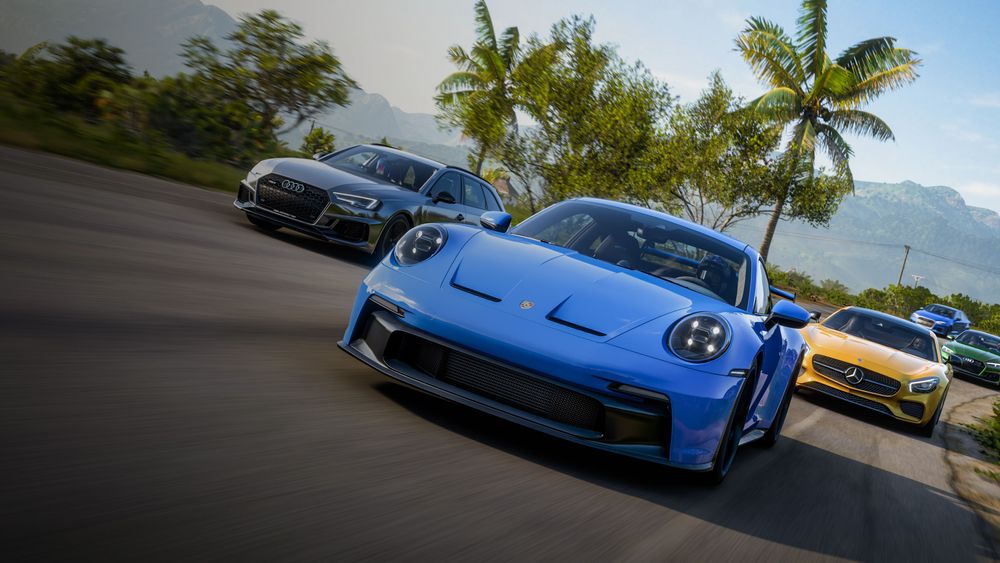 A group of German sports cars race past palm trees in FH5