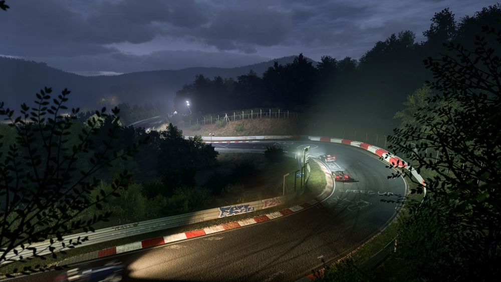 Nordschleife hosting a night race with two cars taking a corner 