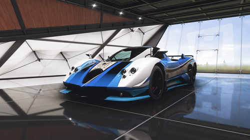 A blue and white themed Pagani Zinque Oreo Edition is parked in a player site garage.