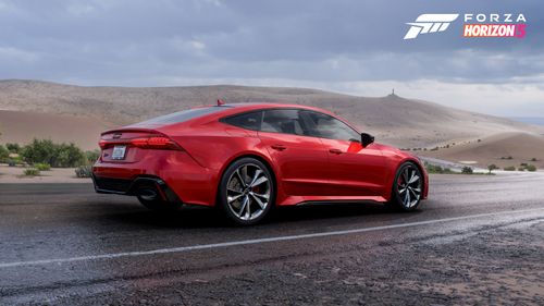 A red Audi RS 7 Sportback is posed on a wet road in Horizon Mexico.
