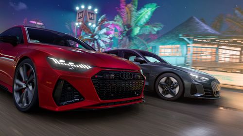 A side view of the 2021 Audi RS e-tron GT and the 2021 Audi RS 7 Sportback as they drive by with blue and pink lights behind them. 