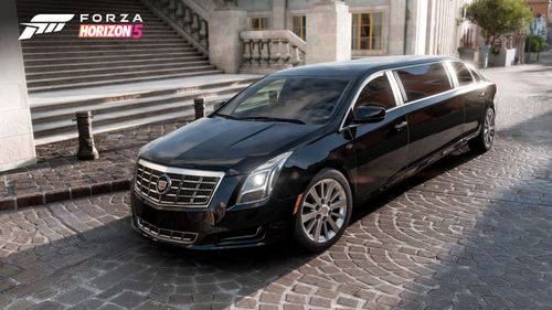 A black Cadillac XTX Limousine is parked in front of city stairs.