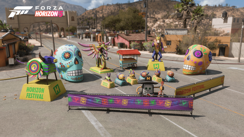 A collection of colorful decorations featuring inflatable skulls, alebrijes and the mariachi gas tank displayed in the middle of a closed road.