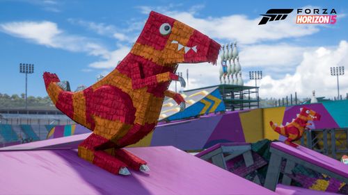 A red and orange smashable dinosaur Piñata prop in the blue and purple colored Stunt Park.