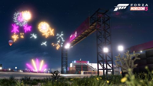 Fireworks on a night sky above a race track