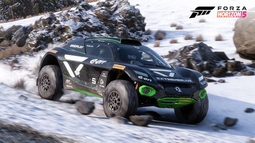 The 2022 Extreme E #5 Veloce Racing adorned in a black and green livery ploughs through the snow upon Mexico's Gran Caldera volcano.
