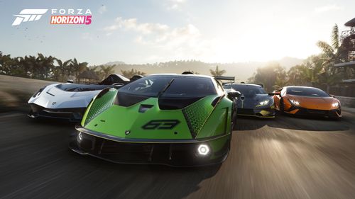 Four Lamborghinis racing on a track during sundown