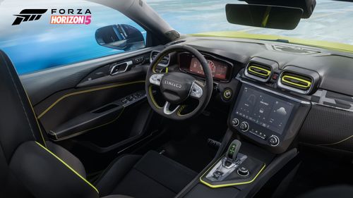 An interior view of the 2021 Lynk & Co 03+ showcasing its steering wheel, touch screen and yellow trim features. 