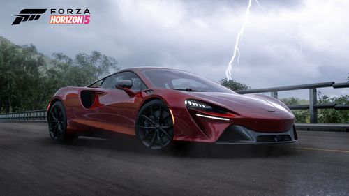 McLaren Artura poised on an open road as lightning strikes on the background