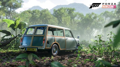 A green 1965 Morris Mini-Traveller parked in a lush rainforest.