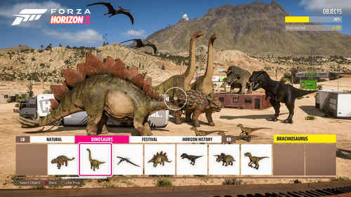 Seven dinosaur props displayed in front of a mountain on a desertic terrain