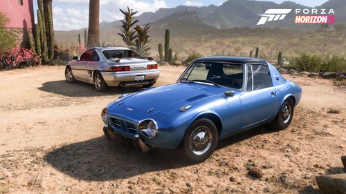A Toyota Sports 800 and Toyota MR-2 are posed in a desert setting.