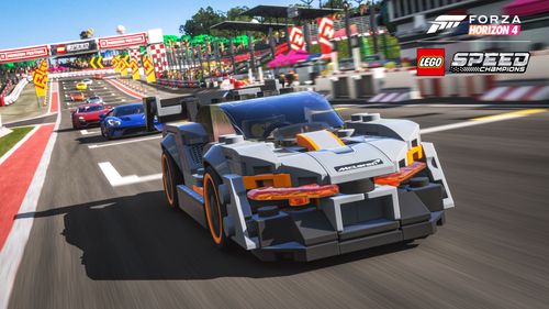 The LEGO Speed Champions McLaren Senna mostly grey with orange highlights leads the way on the LEGO Valley racetrack followed by blue and red cars.
