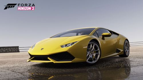 A yellow Lamborghini Huracan is parked on a coastal path with its front wheels turned in and a clear sky in the background.