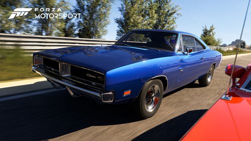 A classic blue muscle car competing with a red car on a racetrack.