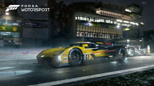 2023 Cadillac Racing V-Series.R #01 in yellow racing at a circuit at night time.  The left side of the car is fully visible as the car races, at speed, while facing to the left of the image, with headlights illuminating the road ahead and trackside.