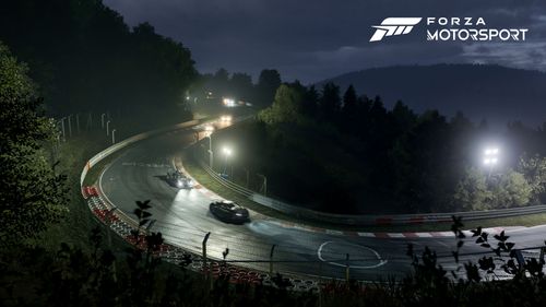 Two cars racing in Nordschleife on an illuminated race track at night