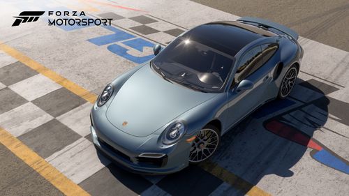 Blue Porsche 911 Turbo parked on the starting line of a race track